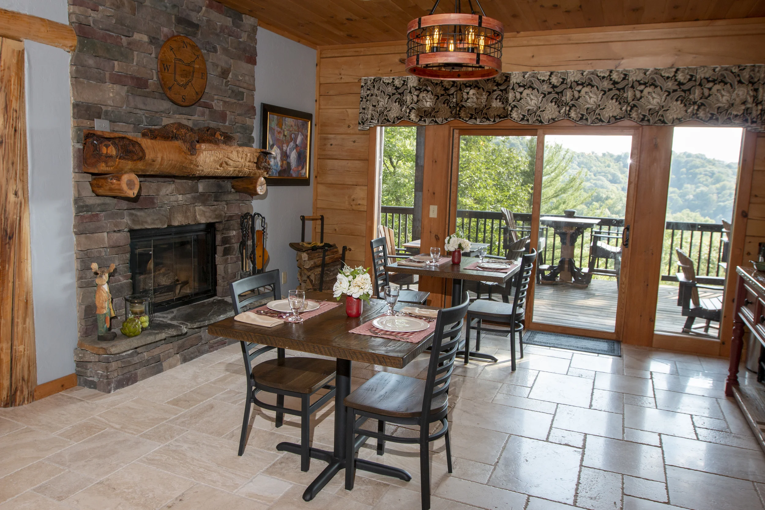 Dining room features five individual tables for couples, fireplace, buffet counter, guest refrigerator, microwave, beverage center and spectacular views of the front gardens and mountain views out the